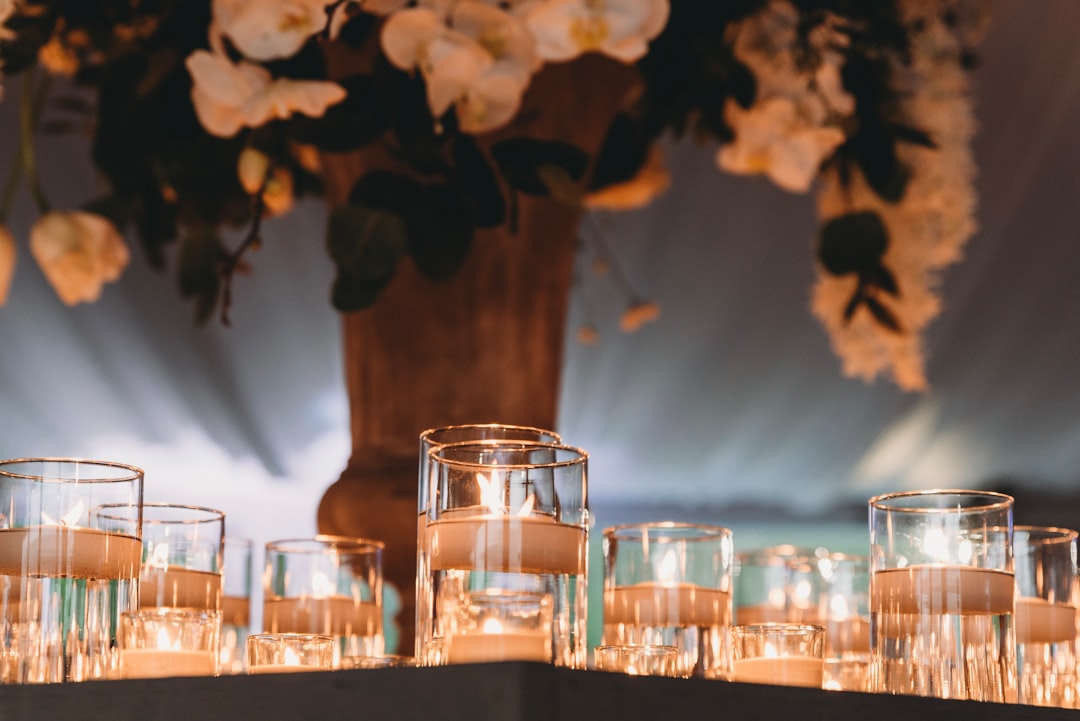 Candles next to a vase with flowers